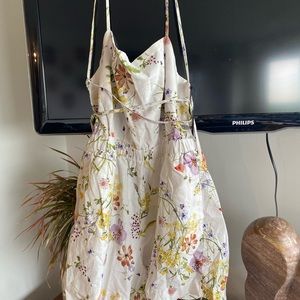 Zara shorts romper ties crossways on open back.